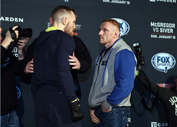 BOSTON, MA - JANUARY 16: UFC featherweights Conor McGregor of Ireland (L) and Dennis Siver of Germany face off for the media at Faneuil Hall on January 16, 2015 in Boston, Massachusetts. (Photo by Jeff Bottari/Zuffa LLC/Zuffa LLC via Getty Images)