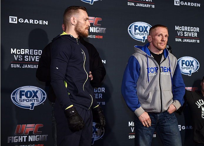 BOSTON, MA - JANUARY 16: UFC featherweights Conor McGregor of Ireland (L) and Dennis Siver of Germany face off for the media at Faneuil Hall on January 16, 2015 in Boston, Massachusetts. (Photo by Jeff Bottari/Zuffa LLC/Zuffa LLC via Getty Images)