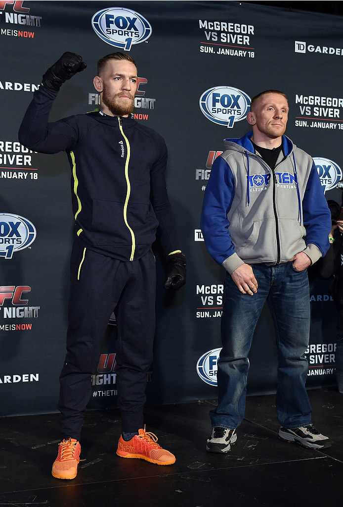 BOSTON, MA - JANUARY 16: UFC featherweights Conor McGregor of Ireland (L) and Dennis Siver of Germany interact with media at Faneuil Hall on January 16, 2015 in Boston, Massachusetts. (Photo by Jeff Bottari/Zuffa LLC/Zuffa LLC via Getty Images)