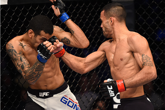 BOSTON, MA - JANUARY 17: (R-L) Rob Font punches Joey Gomez in their bantamweight bout during the UFC Fight Night event inside TD Garden on January 17, 2016 in Boston, Massachusetts. (Photo by Jeff Bottari/Zuffa LLC/Zuffa LLC via Getty Images)