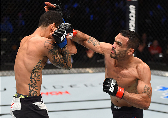 BOSTON, MA - JANUARY 17: (R-L) Rob Font punches Joey Gomez in their bantamweight bout during the UFC Fight Night event inside TD Garden on January 17, 2016 in Boston, Massachusetts. (Photo by Jeff Bottari/Zuffa LLC/Zuffa LLC via Getty Images)
