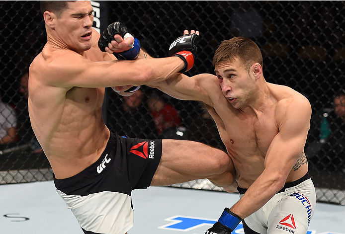 BOSTON, MA - JANUARY 17: (R-L) Kyle Bochniak punches Charles Rosa in their featherweight bout during the UFC Fight Night event inside TD Garden on January 17, 2016 in Boston, Massachusetts. (Photo by Jeff Bottari/Zuffa LLC/Zuffa LLC via Getty Images)