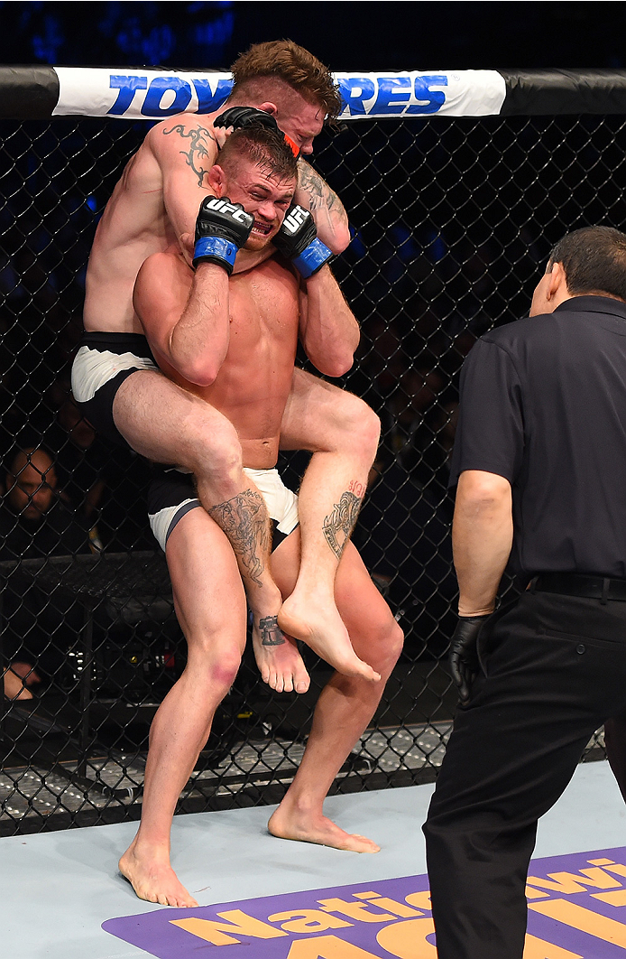 BOSTON, MA - JANUARY 17: (R-L) Paul Felder secures a rear choke submission against Daron Cruickshank in their lightweight bout during the UFC Fight Night event inside TD Garden on January 17, 2016 in Boston, Massachusetts. (Photo by Jeff Bottari/Zuffa LL