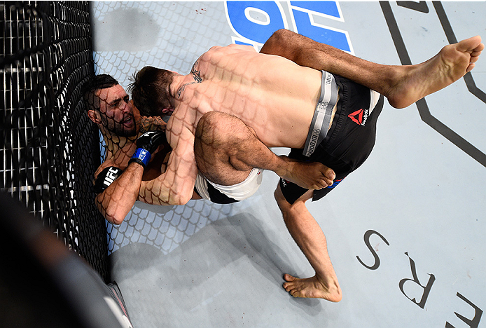 BOSTON, MA - JANUARY 17: (R-L) Chris Wade and Mehdi Baghdad grapple in their lightweight bout during the UFC Fight Night event inside TD Garden on January 17, 2016 in Boston, Massachusetts. (Photo by Jeff Bottari/Zuffa LLC/Zuffa LLC via Getty Images)