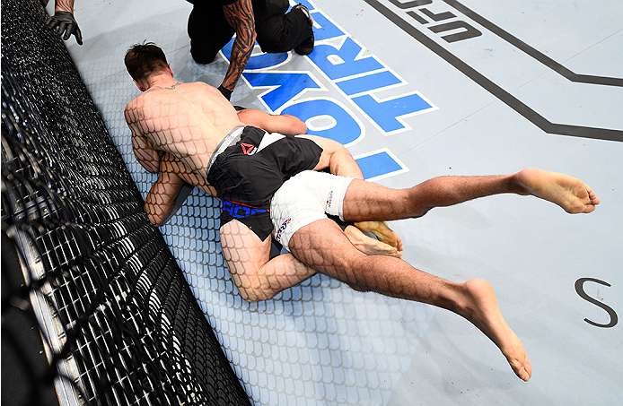 BOSTON, MA - JANUARY 17: (L-R) Chris Wade secures a rear choke submission against Mehdi Bahgdad of France in their lightweight bout during the UFC Fight Night event inside TD Garden on January 17, 2016 in Boston, Massachusetts. (Photo by Jeff Bottari/Zuf