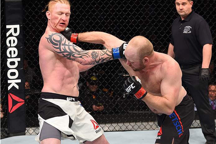 BOSTON, MA - JANUARY 17: (R-L) Tim Boetsch punches Ed Herman in their light heavyweight bout during the UFC Fight Night event inside TD Garden on January 17, 2016 in Boston, Massachusetts. (Photo by Jeff Bottari/Zuffa LLC/Zuffa LLC via Getty Images)