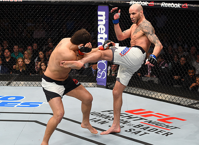 BOSTON, MA - JANUARY 17: (R-L) Ben Saunders kicks Patrick Cote of Canada in their welterweight bout during the UFC Fight Night event inside TD Garden on January 17, 2016 in Boston, Massachusetts. (Photo by Jeff Bottari/Zuffa LLC/Zuffa LLC via Getty Image