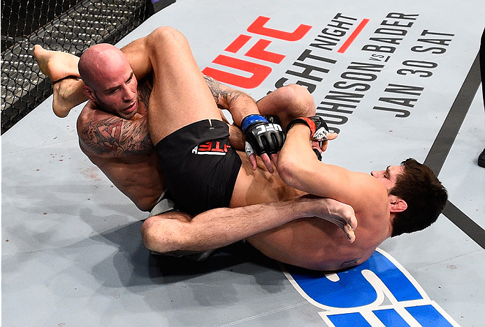 BOSTON, MA - JANUARY 17: (R-L) Patrick Cote of Canada attempts to secure an arm bar submission against Ben Saunders in their welterweight bout during the UFC Fight Night event inside TD Garden on January 17, 2016 in Boston, Massachusetts. (Photo by Jeff