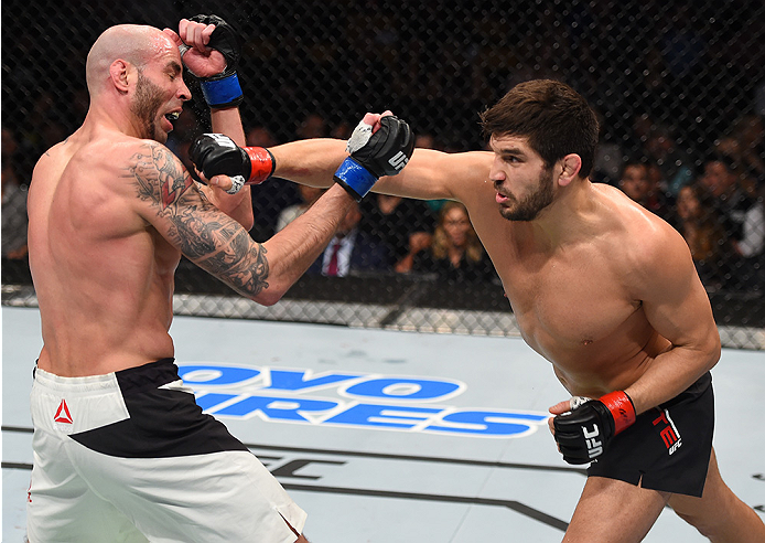 BOSTON, MA - JANUARY 17: (R-L) Patrick Cote of Canada punches Ben Saunders in their welterweight bout during the UFC Fight Night event inside TD Garden on January 17, 2016 in Boston, Massachusetts. (Photo by Jeff Bottari/Zuffa LLC/Zuffa LLC via Getty Ima