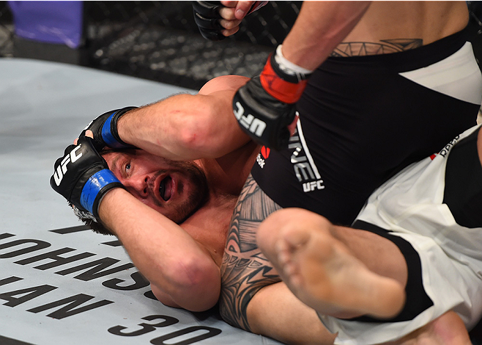 BOSTON, MA - JANUARY 17: Matt Mitrione covers up as Travis Browne punches down in their heavyweight bout during the UFC Fight Night event inside TD Garden on January 17, 2016 in Boston, Massachusetts. (Photo by Jeff Bottari/Zuffa LLC/Zuffa LLC via Getty