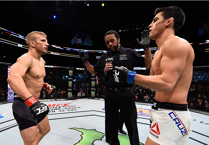 BOSTON, MA - JANUARY 17: (L-R) Opponents TJ Dillashaw and Dominick Cruz receive final instructions from referee Herb Dean before their UFC bantamweight championship bout during the UFC Fight Night event inside TD Garden on January 17, 2016 in Boston, Mas