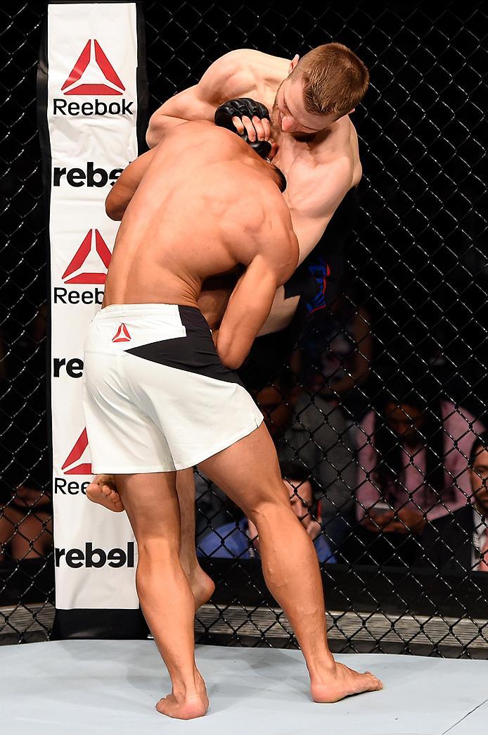 BRISBANE, AUSTRALIA - MARCH 20: (R-L) Dan Hooker of New Zealand attempts a submission against Mark Eddiva of the Philippines in their featherweight bout during the UFC Fight Night event at the Brisbane Entertainment Centre on March 20, 2016 in Brisbane,