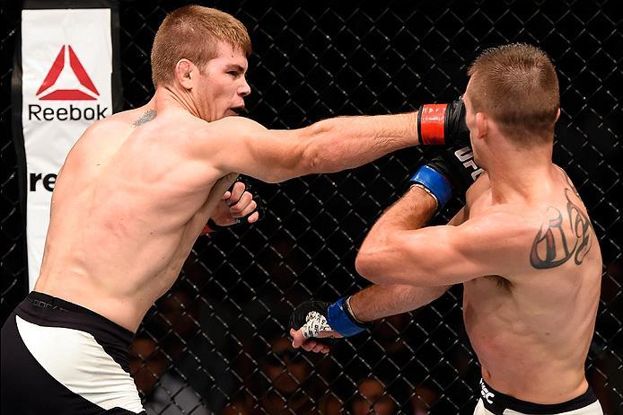 BRISBANE, AUSTRALIA - MARCH 20: (L-R) Jake Matthews of Australia punches Johnny Case of the United States in their lightweight bout during the UFC Fight Night event at the Brisbane Entertainment Centre on March 20, 2016 in Brisbane, Australia. (Photo by