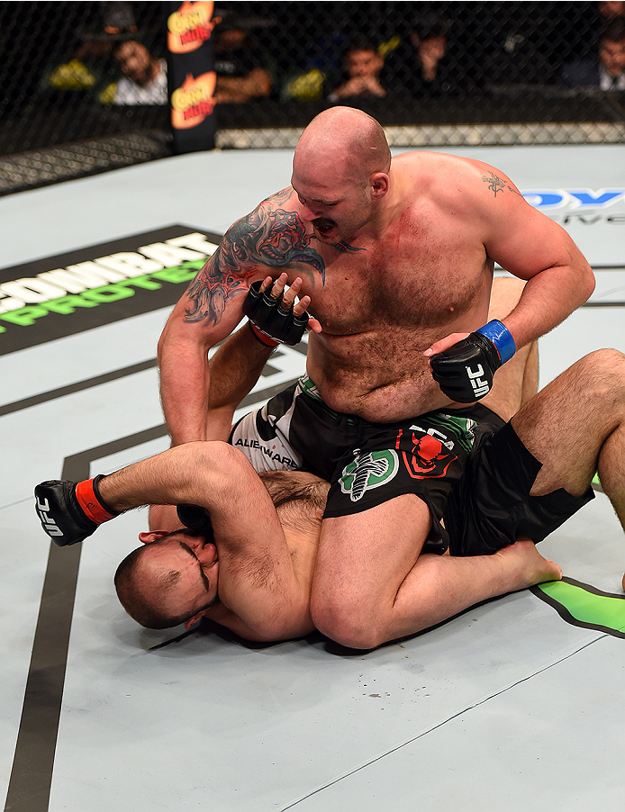 FAIRFAX, VA - APRIL 04: (R-L) Timothy Johnson punches Shamil Abdurakhimov of Russia in their heavyweight fight during the UFC Fight Night event at the Patriot Center on April 4, 2015 in Fairfax, Virginia. (Photo by Josh Hedges/Zuffa LLC/Zuffa LLC via Ge