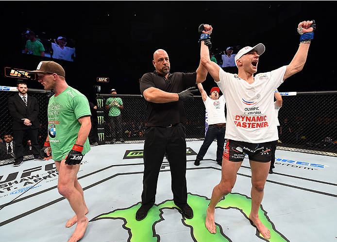 FAIRFAX, VA - APRIL 04: (R-L) Alexander Yakovlev celebrates after defeating Gray Maynard in their lightweight fight during the UFC Fight Night event at the Patriot Center on April 4, 2015 in Fairfax, Virginia. (Photo by Josh Hedges/Zuffa LLC/Zuffa LLC v