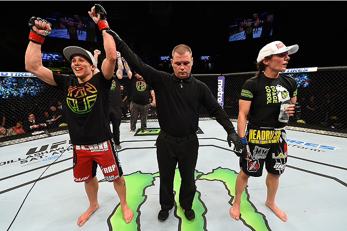 FAIRFAX, VA - APRIL 04: (L-R) Liz Carmouche celebrates after defeating Lauren Murphy in their women's bantamweight fight during the UFC Fight Night event at the Patriot Center on April 4, 2015 in Fairfax, Virginia. (Photo by Josh Hedges/Zuffa LLC/Zuffa L