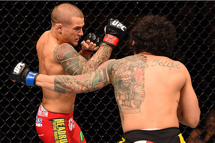 FAIRFAX, VA - APRIL 04: (L-R) Dustin Poirier punches Diego Ferreira in their lightweight fight during the UFC Fight Night event at the Patriot Center on April 4, 2015 in Fairfax, Virginia. (Photo by Josh Hedges/Zuffa LLC/Zuffa LLC via Getty Images)
