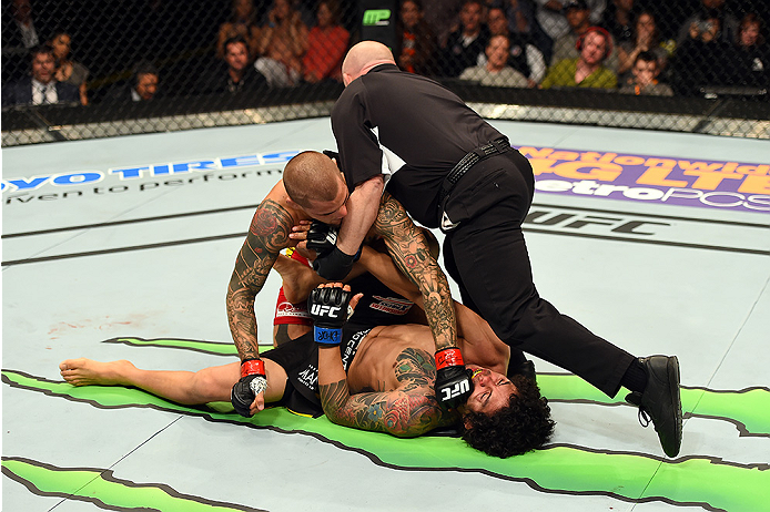 FAIRFAX, VA - APRIL 04: (L-R) Dustin Poirier is stopped by the referee after knocking out Diego Ferreira in their lightweight fight during the UFC Fight Night event at the Patriot Center on April 4, 2015 in Fairfax, Virginia. (Photo by Josh Hedges/Zuffa
