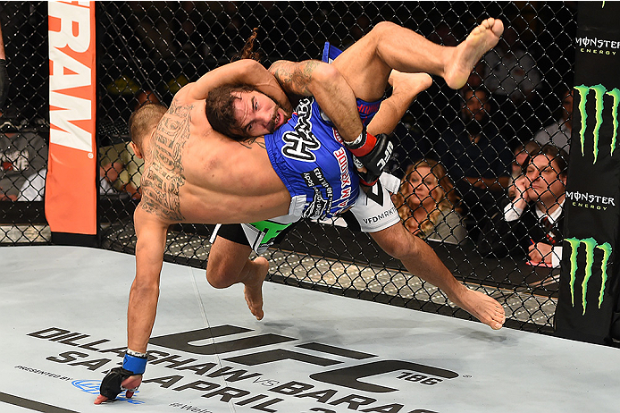 FAIRFAX, VA - APRIL 04: (R-L) Clay Guida takes down Robbie Peralta in their featherweight fight during the UFC Fight Night event at the Patriot Center on April 4, 2015 in Fairfax, Virginia. (Photo by Josh Hedges/Zuffa LLC/Zuffa LLC via Getty Images)