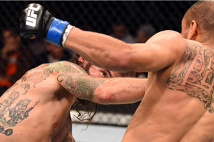 FAIRFAX, VA - APRIL 04: (L-R) Clay Guida punches Robbie Peralta in their featherweight fight during the UFC Fight Night event at the Patriot Center on April 4, 2015 in Fairfax, Virginia. (Photo by Josh Hedges/Zuffa LLC/Zuffa LLC via Getty Images)