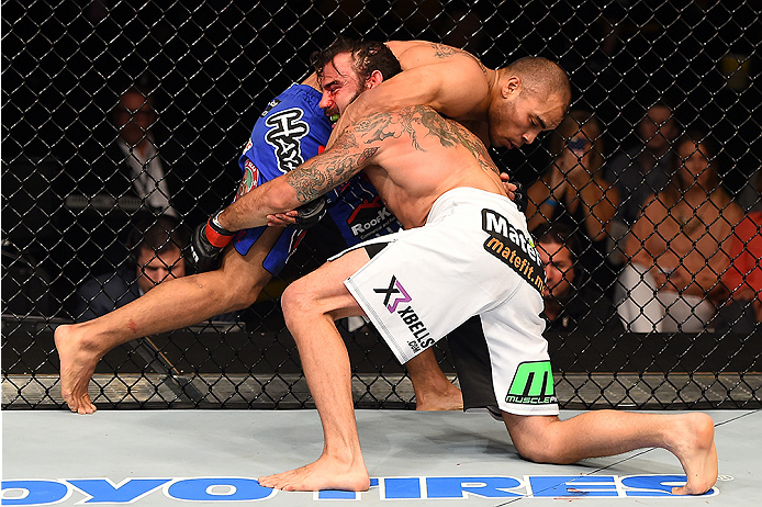 FAIRFAX, VA - APRIL 04: (R-L) Clay Guida attempts a take down against Robbie Peralta in their featherweight fight during the UFC Fight Night event at the Patriot Center on April 4, 2015 in Fairfax, Virginia. (Photo by Josh Hedges/Zuffa LLC/Zuffa LLC via