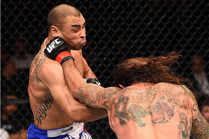 FAIRFAX, VA - APRIL 04: (R-L) Clay Guida punches Robbie Peralta in their featherweight fight during the UFC Fight Night event at the Patriot Center on April 4, 2015 in Fairfax, Virginia. (Photo by Josh Hedges/Zuffa LLC/Zuffa LLC via Getty Images)