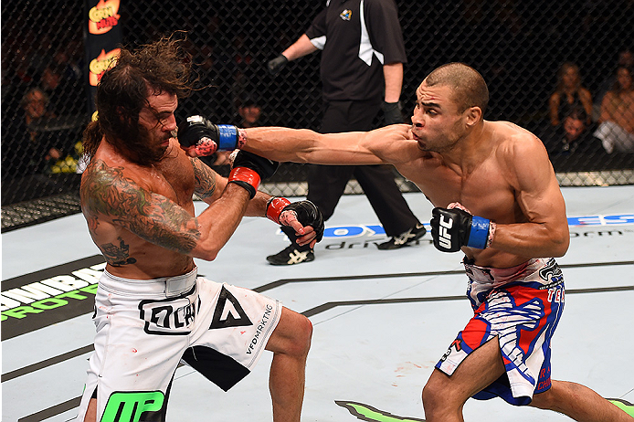 FAIRFAX, VA - APRIL 04: (R-L) Robbie Peralta punches Clay Guida in their featherweight fight during the UFC Fight Night event at the Patriot Center on April 4, 2015 in Fairfax, Virginia. (Photo by Josh Hedges/Zuffa LLC/Zuffa LLC via Getty Images)