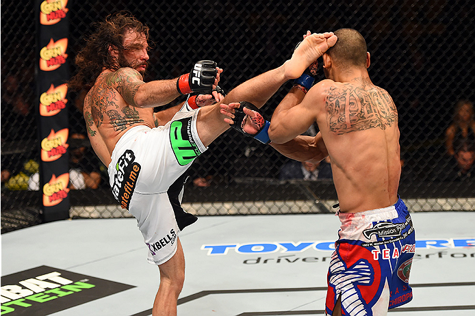 FAIRFAX, VA - APRIL 04: (L-R) Clay Guida kicks Robbie Peralta in their featherweight fight during the UFC Fight Night event at the Patriot Center on April 4, 2015 in Fairfax, Virginia. (Photo by Josh Hedges/Zuffa LLC/Zuffa LLC via Getty Images)