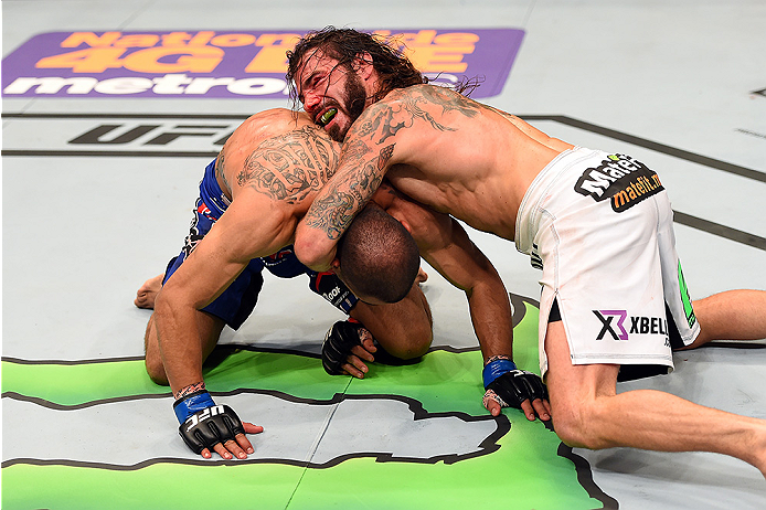 FAIRFAX, VA - APRIL 04: (R-L) Clay Guida attempts to submit Robbie Peralta in their featherweight fight during the UFC Fight Night event at the Patriot Center on April 4, 2015 in Fairfax, Virginia. (Photo by Josh Hedges/Zuffa LLC/Zuffa LLC via Getty Imag