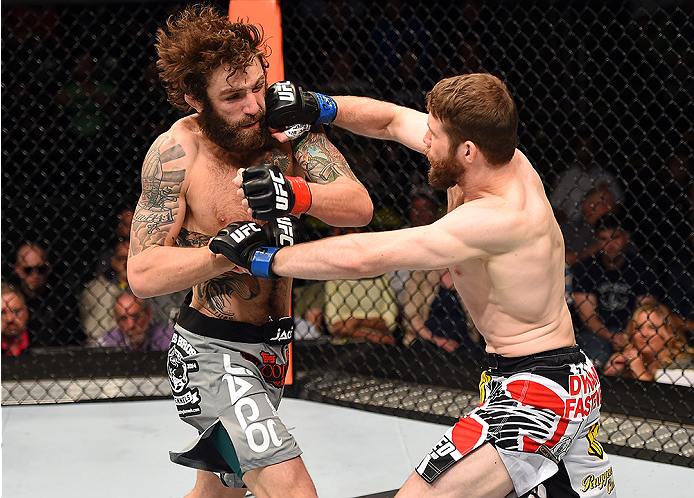 FAIRFAX, VA - APRIL 04: (R-L) Mitch Clarke punches Michael Chiesa in their lightweight fight during the UFC Fight Night event at the Patriot Center on April 4, 2015 in Fairfax, Virginia. (Photo by Josh Hedges/Zuffa LLC/Zuffa LLC via Getty Images)