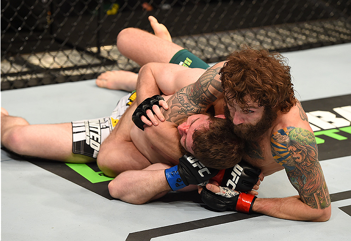 FAIRFAX, VA - APRIL 04: (R-L) Michael Chiesa attempts a submission against Mitch Clarke in their lightweight fight during the UFC Fight Night event at the Patriot Center on April 4, 2015 in Fairfax, Virginia. (Photo by Josh Hedges/Zuffa LLC/Zuffa LLC via