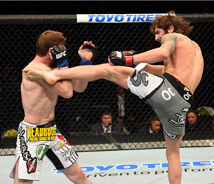 FAIRFAX, VA - APRIL 04: (R-L) Michael Chiesa kicks Mitch Clarke in their lightweight fight during the UFC Fight Night event at the Patriot Center on April 4, 2015 in Fairfax, Virginia. (Photo by Josh Hedges/Zuffa LLC/Zuffa LLC via Getty Images)