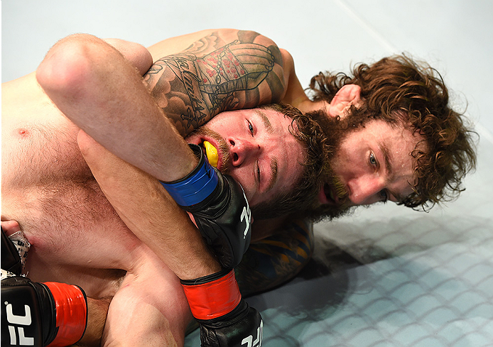 FAIRFAX, VA - APRIL 04: (R-L) Michael Chiesa attempts a submission against Mitch Clarke in their lightweight fight during the UFC Fight Night event at the Patriot Center on April 4, 2015 in Fairfax, Virginia. (Photo by Josh Hedges/Zuffa LLC/Zuffa LLC via