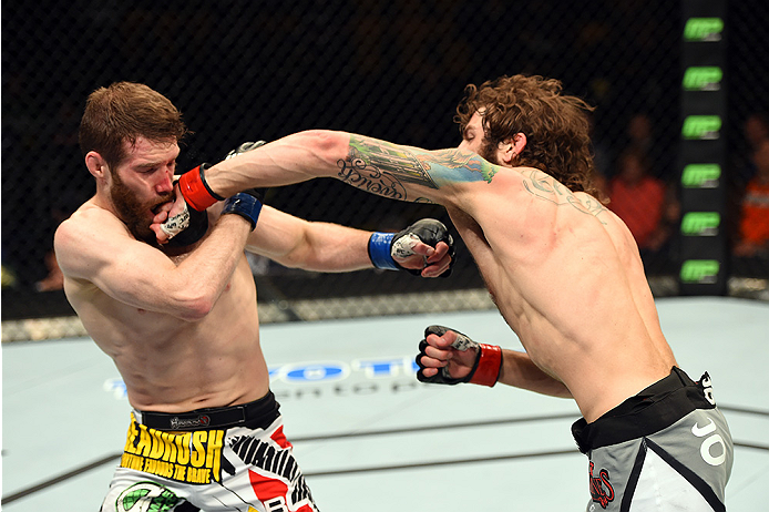 FAIRFAX, VA - APRIL 04: (R-L) Michael Chiesa punches Mitch Clarke in their lightweight fight during the UFC Fight Night event at the Patriot Center on April 4, 2015 in Fairfax, Virginia. (Photo by Josh Hedges/Zuffa LLC/Zuffa LLC via Getty Images)
