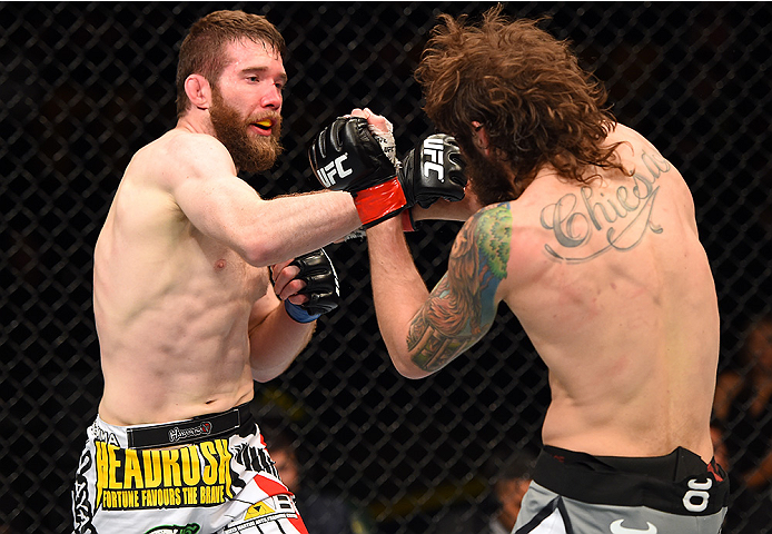 FAIRFAX, VA - APRIL 04: (L-R) Mitch Clarke punches Michael Chiesa in their lightweight fight during the UFC Fight Night event at the Patriot Center on April 4, 2015 in Fairfax, Virginia. (Photo by Josh Hedges/Zuffa LLC/Zuffa LLC via Getty Images)