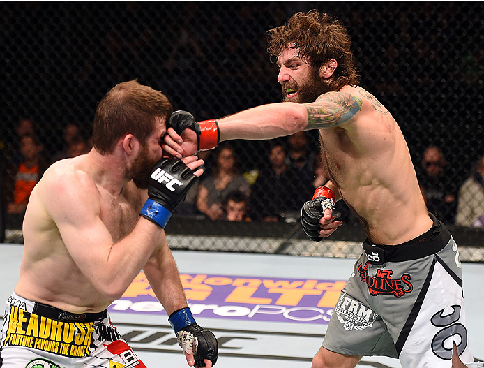 FAIRFAX, VA - APRIL 04: (R-L) Michael Chiesa punches Mitch Clarke in their lightweight fight during the UFC Fight Night event at the Patriot Center on April 4, 2015 in Fairfax, Virginia. (Photo by Josh Hedges/Zuffa LLC/Zuffa LLC via Getty Images)