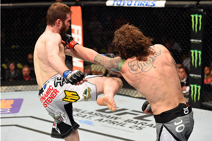 FAIRFAX, VA - APRIL 04: (R-L) Michael Chiesa punches Mitch Clarke in their lightweight fight during the UFC Fight Night event at the Patriot Center on April 4, 2015 in Fairfax, Virginia. (Photo by Josh Hedges/Zuffa LLC/Zuffa LLC via Getty Images)