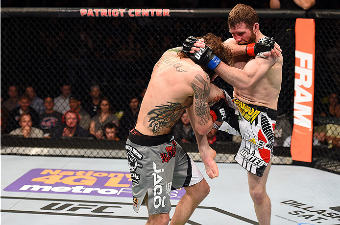 FAIRFAX, VA - APRIL 04: (R-L) Mitch Clarke lands a knee to Michael Chiesa in their lightweight fight during the UFC Fight Night event at the Patriot Center on April 4, 2015 in Fairfax, Virginia. (Photo by Josh Hedges/Zuffa LLC/Zuffa LLC via Getty Images)