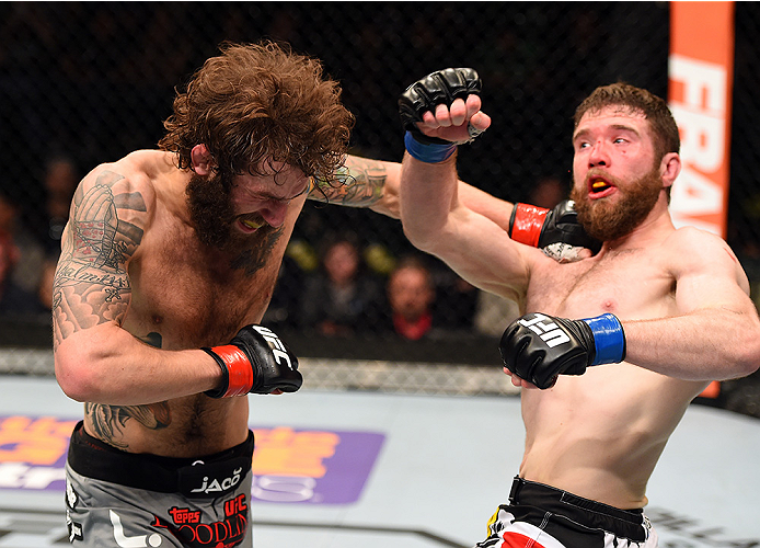 FAIRFAX, VA - APRIL 04: (L-R) Michael Chiesa punches Mitch Clarke in their lightweight fight during the UFC Fight Night event at the Patriot Center on April 4, 2015 in Fairfax, Virginia. (Photo by Josh Hedges/Zuffa LLC/Zuffa LLC via Getty Images)