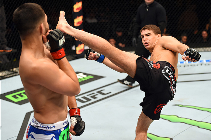 FAIRFAX, VA - APRIL 04: (R-L) Al Iaquinta throws a kick against Jorge Masvidal in their lightweight fight during the UFC Fight Night event at the Patriot Center on April 4, 2015 in Fairfax, Virginia. (Photo by Josh Hedges/Zuffa LLC/Zuffa LLC via Getty Im