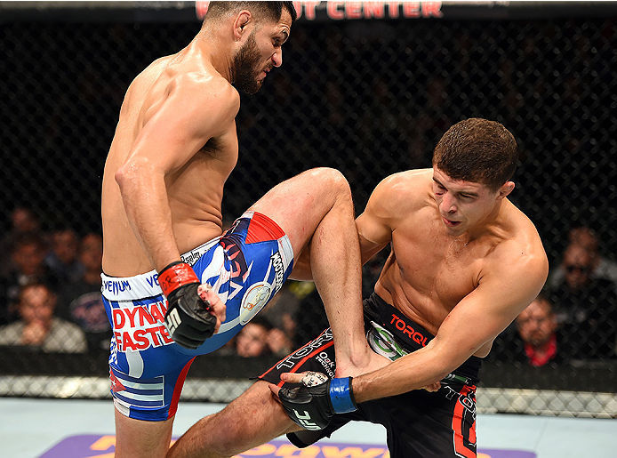 FAIRFAX, VA - APRIL 04: (L-R) Jorge Masvidal throws a flying knee against Al Iaquinta in their lightweight fight during the UFC Fight Night event at the Patriot Center on April 4, 2015 in Fairfax, Virginia. (Photo by Josh Hedges/Zuffa LLC/Zuffa LLC via G