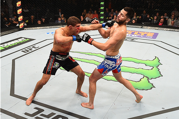 FAIRFAX, VA - APRIL 04: (L-R) Al Iaquinta punches Jorge Masvidal in their lightweight fight during the UFC Fight Night event at the Patriot Center on April 4, 2015 in Fairfax, Virginia. (Photo by Josh Hedges/Zuffa LLC/Zuffa LLC via Getty Images)