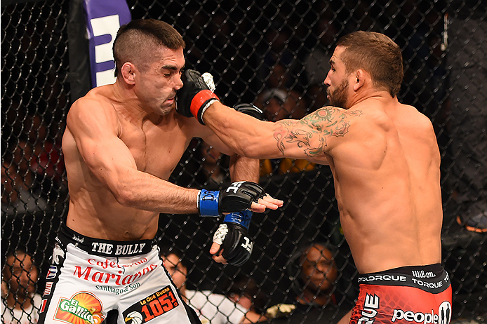 FAIRFAX, VA - APRIL 04: (EDITOR'S NOTE: Alternative crop for #468617858) (R-L) Chad Mendes punches Ricardo Lamas in their featherweight fight during the UFC Fight Night event at the Patriot Center on April 4, 2015 in Fairfax, Virginia. (Photo by Josh Hed