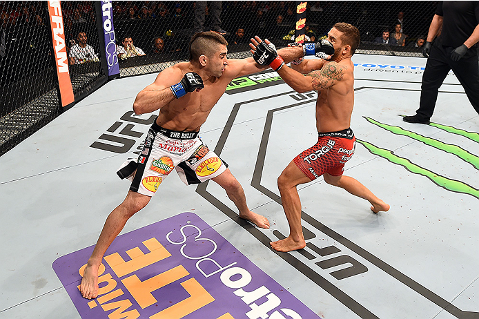 FAIRFAX, VA - APRIL 04: (L-R) Ricardo Lamas punches Chad Mendes in their featherweight fight during the UFC Fight Night event at the Patriot Center on April 4, 2015 in Fairfax, Virginia. (Photo by Josh Hedges/Zuffa LLC/Zuffa LLC via Getty Images)