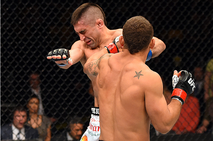 FAIRFAX, VA - APRIL 04: (R-L) Chad Mendes punches Ricardo Lamas in their featherweight fight during the UFC Fight Night event at the Patriot Center on April 4, 2015 in Fairfax, Virginia. (Photo by Josh Hedges/Zuffa LLC/Zuffa LLC via Getty Images)