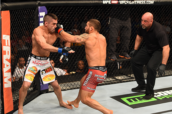 FAIRFAX, VA - APRIL 04: (R-L) Chad Mendes punches Ricardo Lamas in their featherweight fight during the UFC Fight Night event at the Patriot Center on April 4, 2015 in Fairfax, Virginia. (Photo by Josh Hedges/Zuffa LLC/Zuffa LLC via Getty Images)