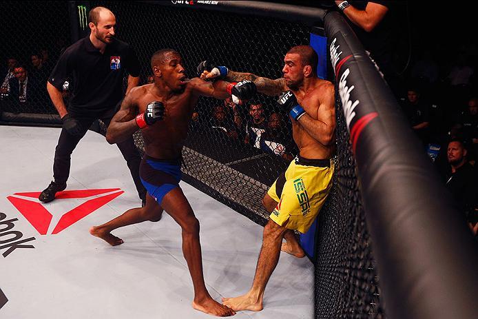 HAMBURG, GERMANY - SEPTEMBER 03: Leandro Issa (R) of Brazil punches Taylor Lapilus (L) of France compete in their Bantamweight Bout during the UFC Fight Night held at Barclaycard Arena on September 3, 2016 in Hamburg, Germany. (Photo by Dean Mouhtaropou