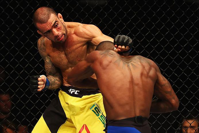 HAMBURG, GERMANY - SEPTEMBER 03: Leandro Issa (L) of Brazil punches Taylor Lapilus (R) of France compete in their Bantamweight Bout during the UFC Fight Night held at Barclaycard Arena on September 3, 2016 in Hamburg, Germany. (Photo by Dean Mouhtaropou