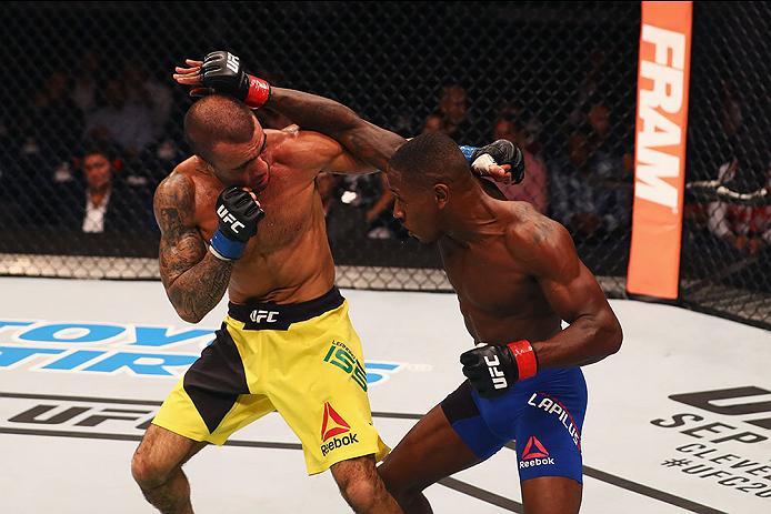 HAMBURG, GERMANY - SEPTEMBER 03: Taylor Lapilus (R) of France punches Leandro Issa (L) of Brazil in their Bantamweight Bout during the UFC Fight Night held at Barclaycard Arena on September 3, 2016 in Hamburg, Germany. (Photo by Dean Mouhtaropoulos/Zuf