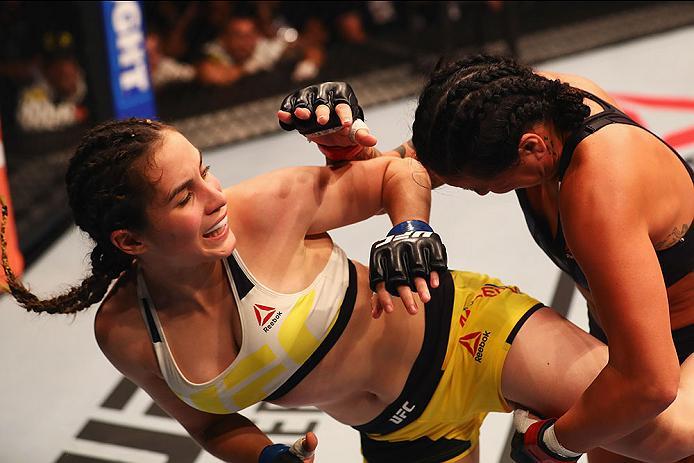 HAMBURG, GERMANY - SEPTEMBER 03: Veronica Macedo (L) of Venezuela kicks facing Ashlee Evans-Smith (R) of the USA compete in their Womens Bantamweight Bout during the UFC Fight Night held at Barclaycard Arena on September 3, 2016 in Hamburg, Germany. (Ph